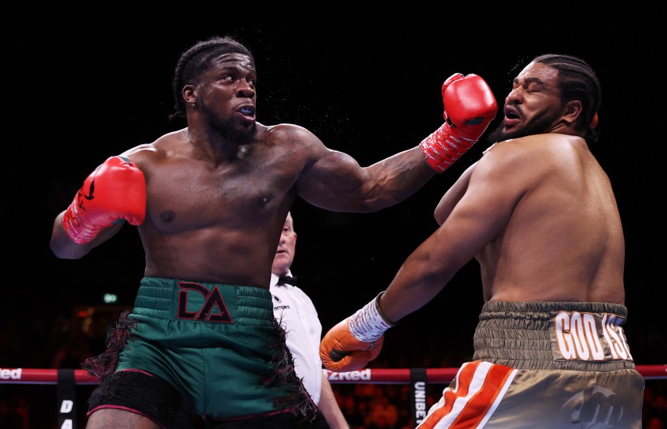 David Adeleye punches Jeamie Tshikeva during a boxing match.