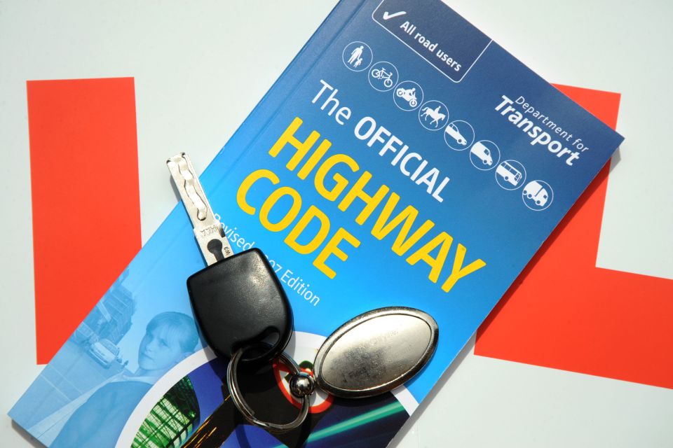 Car key and The Official Highway Code book.