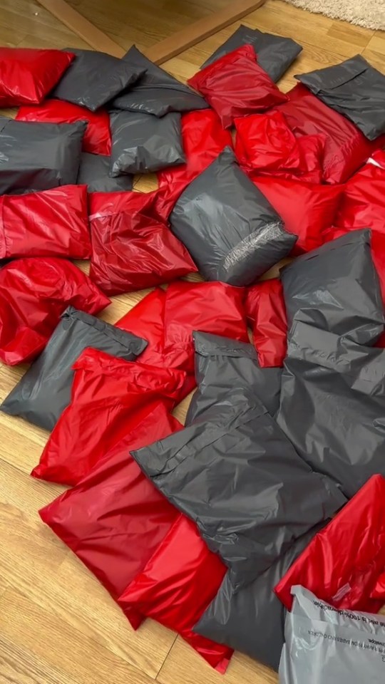 Pile of red and gray shipping bags.