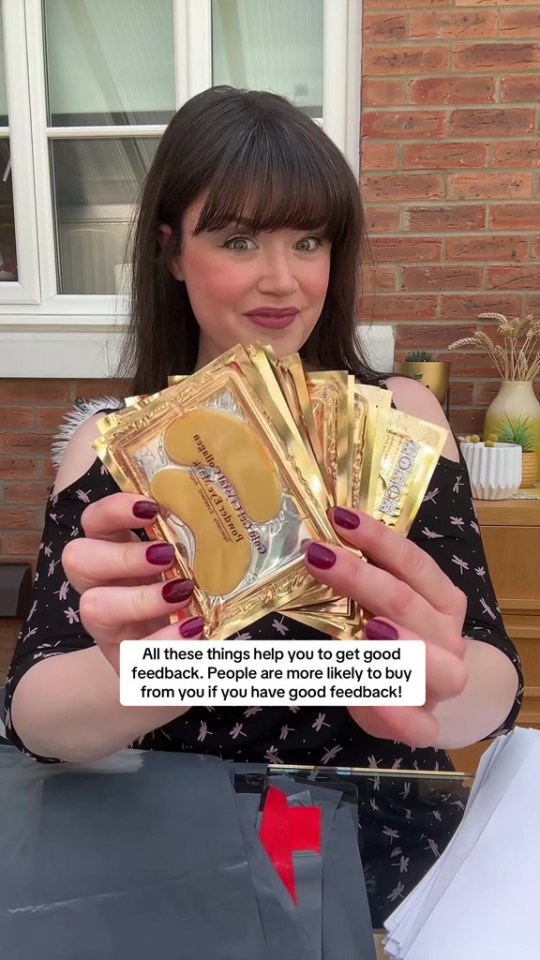 Woman holding gold eye masks and packaging materials.