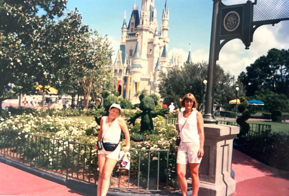 Photo of a young girl and woman in front of Cinderella Castle at Walt Disney World.