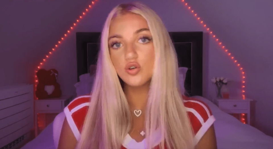 Woman with blonde hair speaking to camera in bedroom.