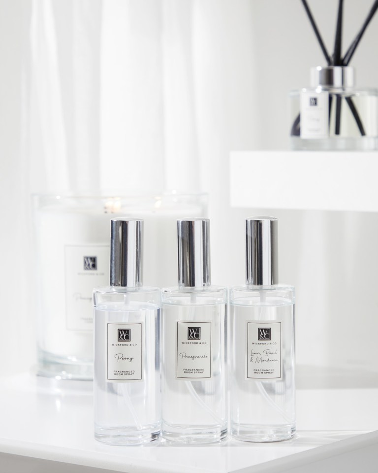 Three bottles of Wickford & Co. fragranced room spray in Peony, Pomegranate, and Lime, Basil & Mandarin scents.