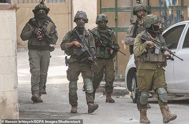 IDF soldiers seen among Palestinian homes during a raid at the Balata refugee camp on August 11 2025