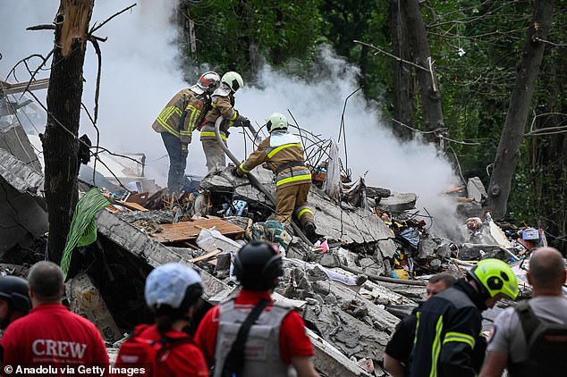 Emergency service teams working to pull out people trapped under the rubble after a Russian attack earlier this year