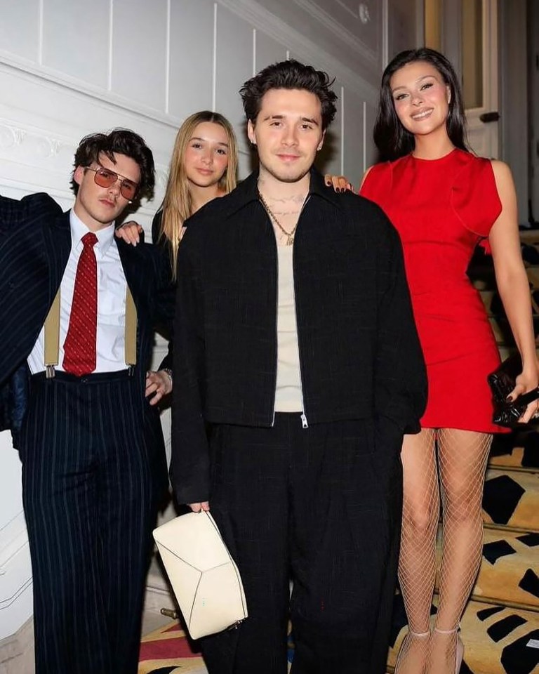 Four young adults and a teenager posing for a photo.
