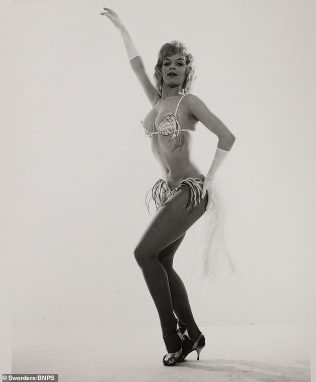 The main collection of 24 black and white photos features showgirls from the Cabaret Club in revealing outfits, extravagant fur numbers and even topless poses