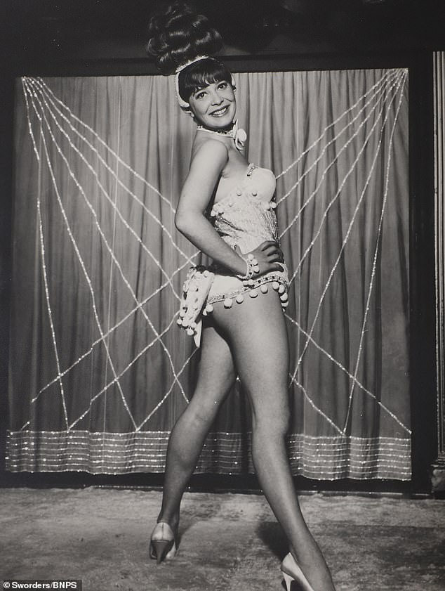 A Cabaret Club showgirl poses in risque fashion for the photo shoot