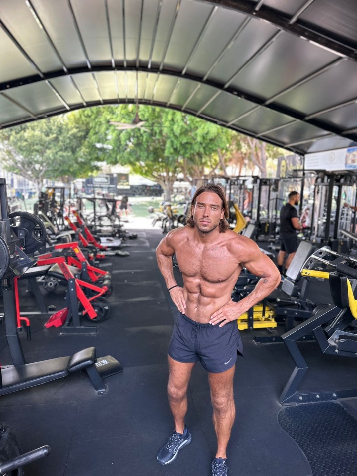 Man posing in a gym.