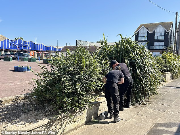 Police officers carry out searches near the scene in the Leysdown-on-Sea resort on the Isle of Sheppey on Monday