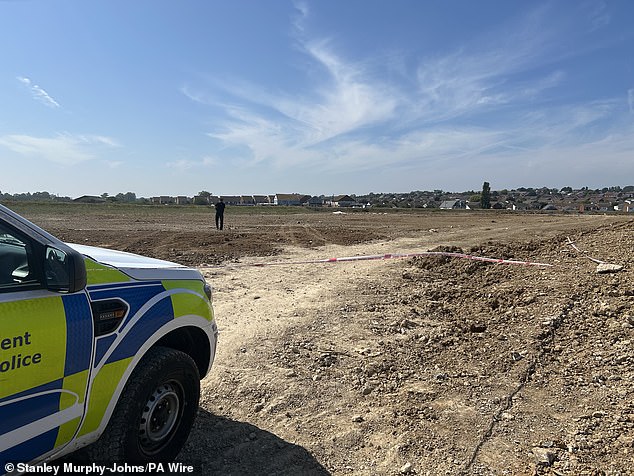 A police cordon was put up in a large clearing behind the beach in front of a caravan park