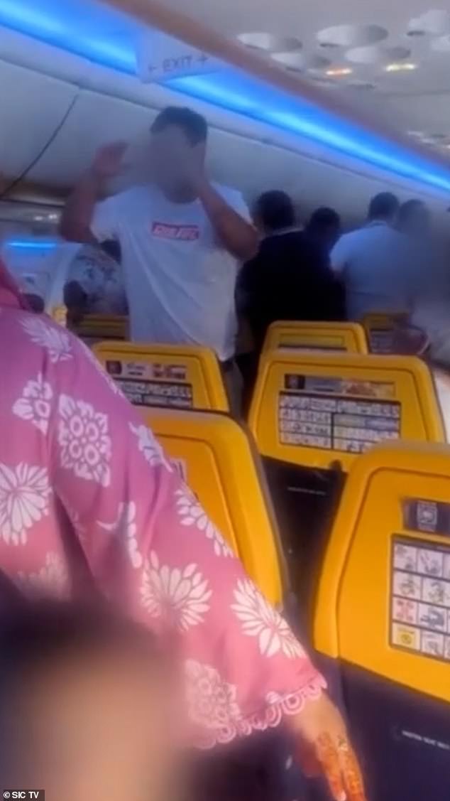 One man appeared to restrain another in front of the mum trying to console her young child