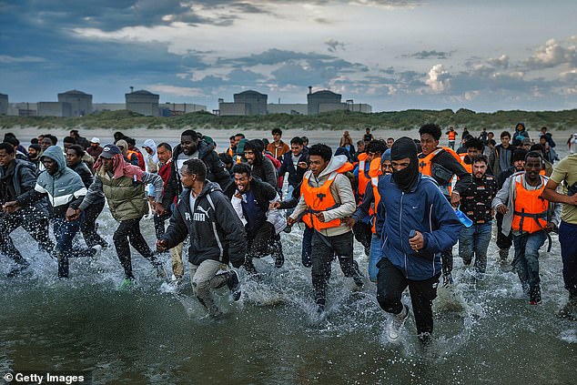Migrants were seen sprinting into the surf at Gravelines beach, northern France, to get aboard a smugglers' taxi boat