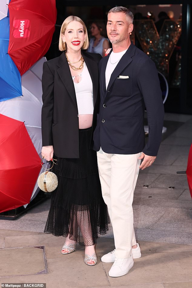 Katherine looked incredible in the plunging white top which she layered under an oversized blazer