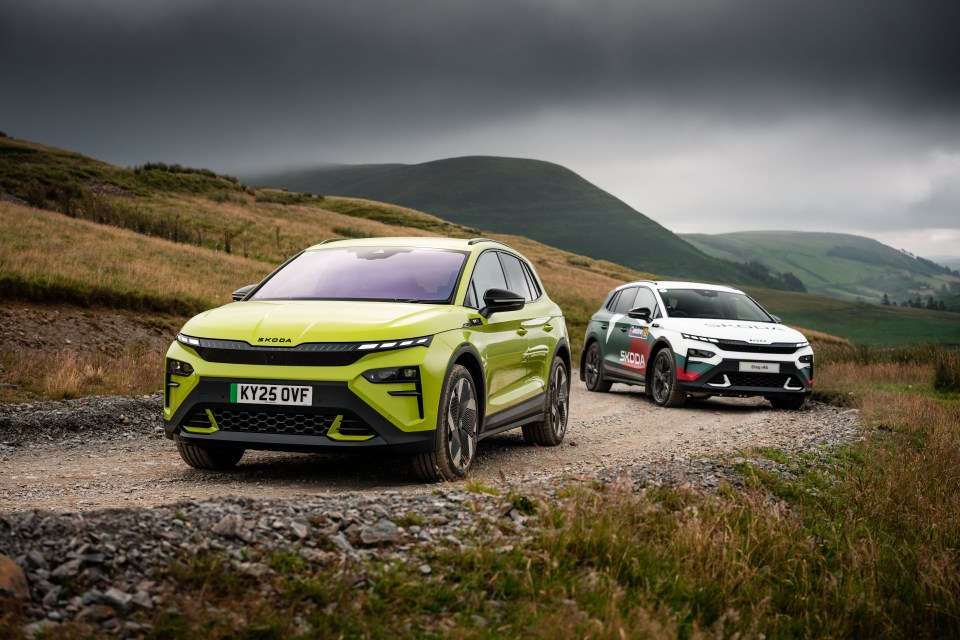 Two Skoda cars driving on a gravel road.