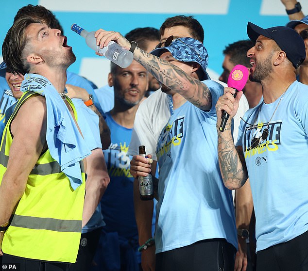 The 29-year-old pictured on stage during the Treble Parade in Manchester in 2023; he admitted to being in a 'world of pain' after a three-day bender celebration