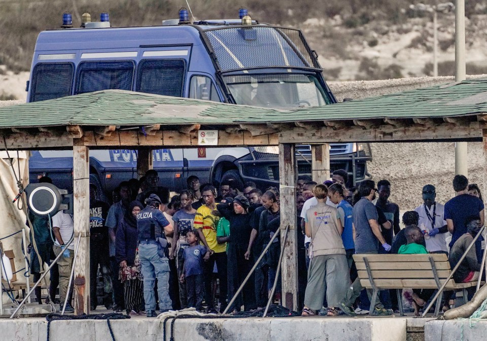 Migrant survivors on a dock after a shipwreck in Lampedusa, Italy.