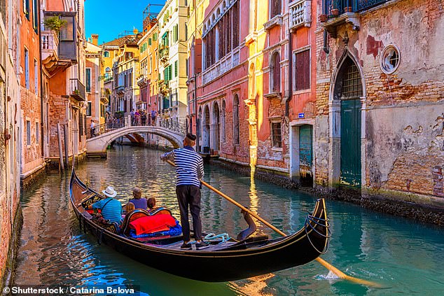 Content creators recently tipped off tourists about the traghetto gondola - a cheap ferry service used by locals to cross the Grand Canal at points where there are no bridges. Pictured: A narrow canal with gondola and bridge in Venice, Italy