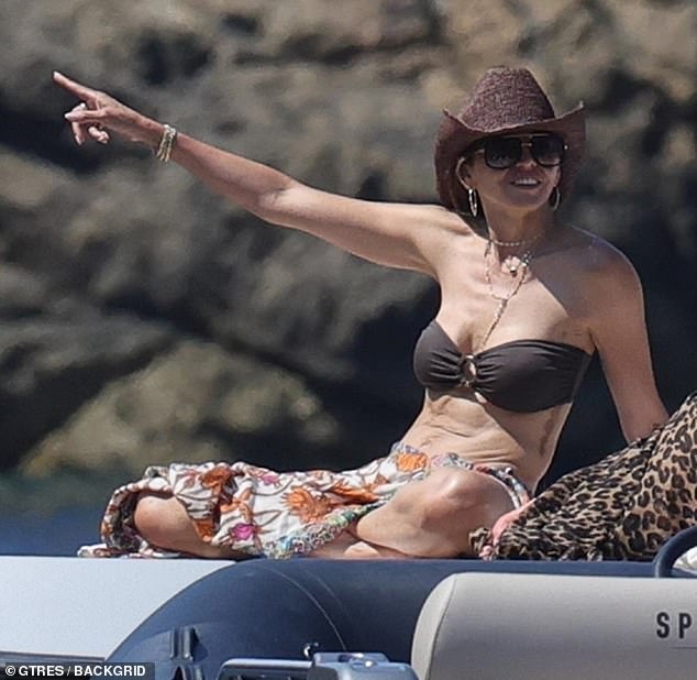 Matt was joined on the yacht by his wife of 19 years, Luciana Bozán Barroso, who flaunted her bikini body in a bandeau, floral sarong, and brown cowboy hat