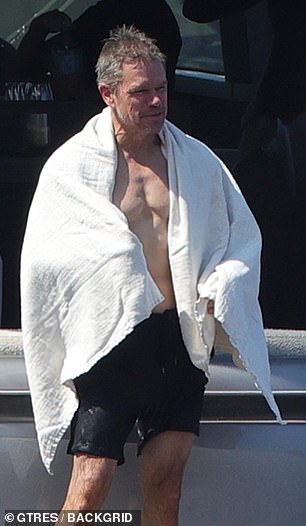 After his swim, Matt dried off his glistening wet body and wrapped the towel around his shoulders
