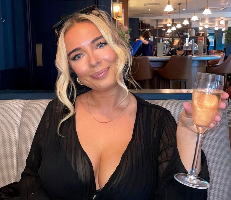 Molly-May Watson holding a glass of champagne.