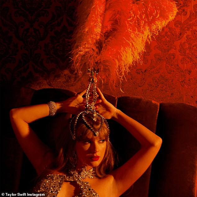 Taylor wowed in a huge red feathered headpiece and dazzling bodysuit