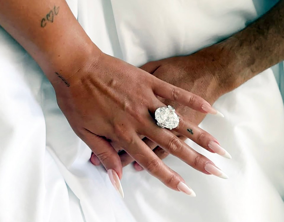 Close-up of a large diamond ring on a woman's finger.