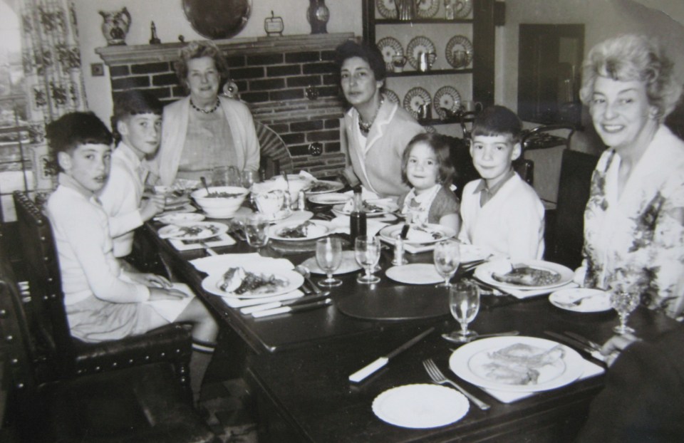 Black and white photo of a family at a Sunday lunch.