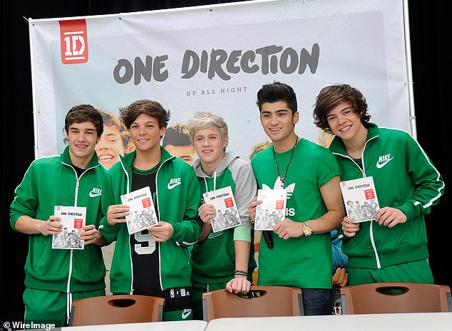 Malike (second right) and the rest of the band signed March 17, 2012