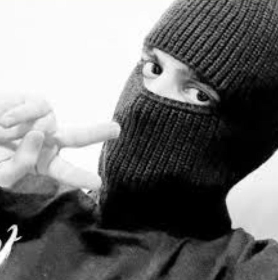 Black and white TikTok photo of a person wearing a balaclava.