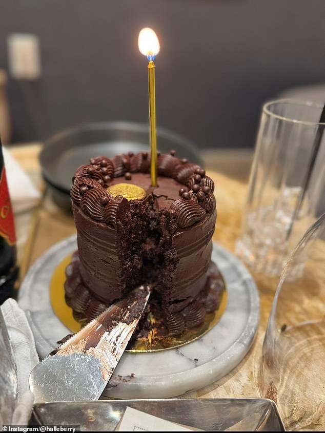 There was also a photograph of a dark chocolate cake with a gold candle