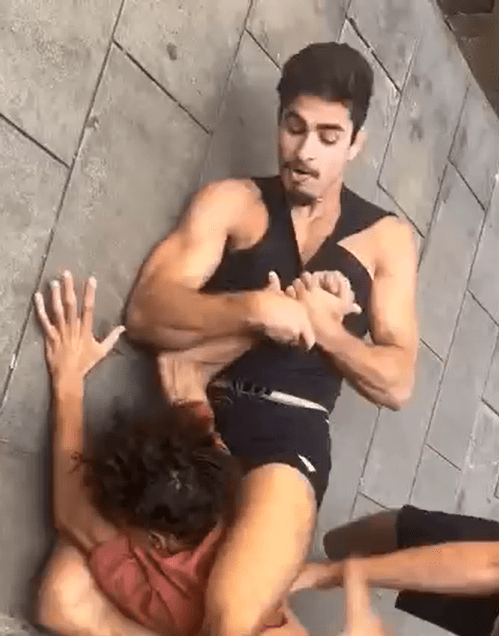 Two people performing a maneuver on the ground.