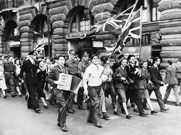 Servicemen and women celebrate with other Londoners in Piccadilly on VJ Day, August 15, 1945