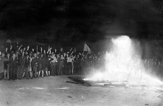 Londoners and Americans celebrate around a huge bonfire in Chinatown, August 14, 1945