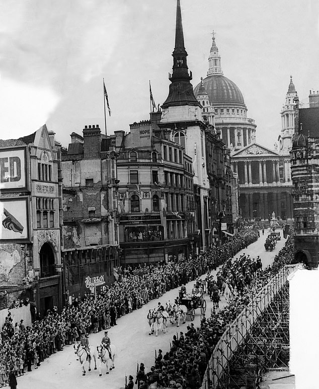 Crowds line the streets to watch the passing of the Royal procession after a service at St Paul's Cathedral, August 19, 1945
