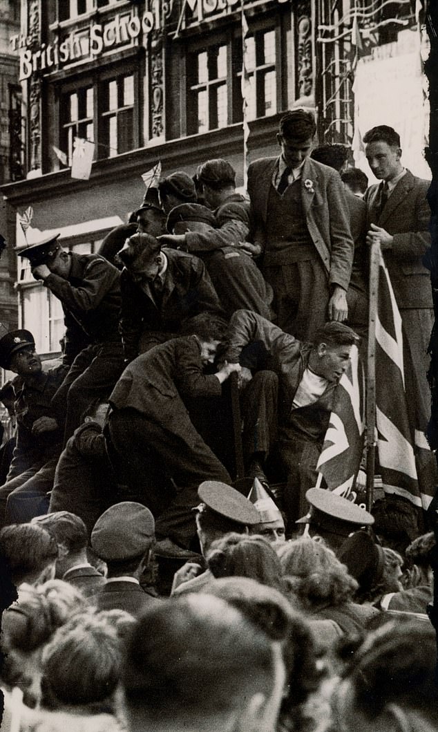Soldiers and sailors trying to get a better view of VJ Day celebrations, August 19, 1945
