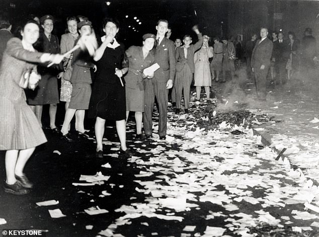 Revellers crowd around a bonfire in Lower Regent Street during VJ celebrations, August 11, 1945