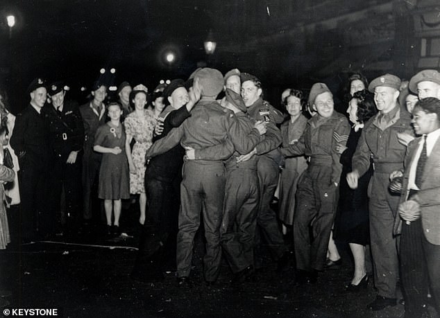 Soldiers celebrate during VJ celebrations in London, August 11, 1945