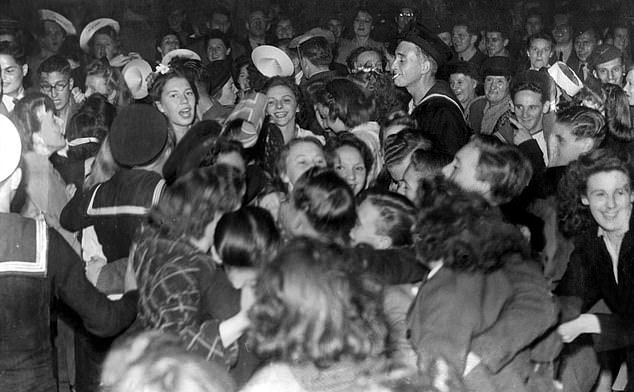 Picture shows crowds dancing and singing in Leicester Square after the first news of an imminent Japanese surrender was heard, August 10, 1945