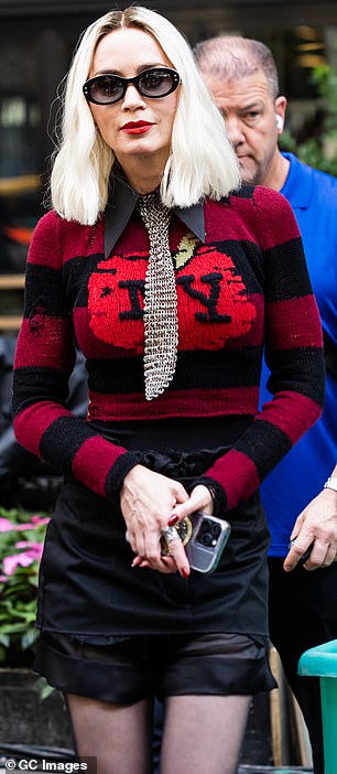 Emily's fashion-forward outfit included a trendily torn, scarlet and black striped top with 'NY' splashed across the front, perfectly fitted to her enviably lithe frame