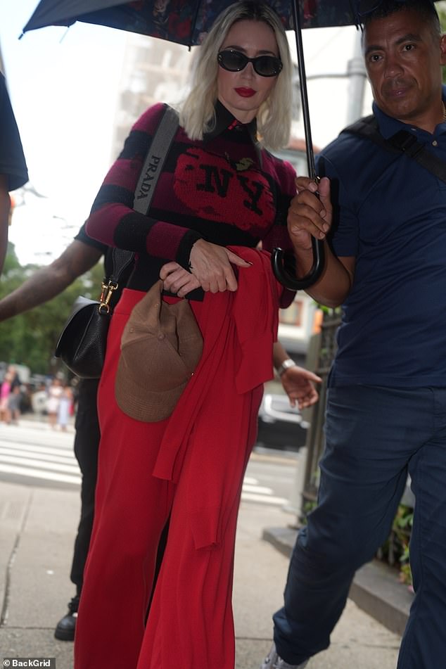 During the sweltering New York August day, a member of the crew could be seen walking alongside Emily holding an umbrella over her to ward off the rays
