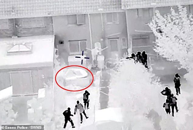 A police helicopter's thermal camera shows Hursham hiding in a hot tub, circled, as police train their rifles and move in. He was one of three people who were caught on camera leading officers on a high-speed chase the wrong way down the A127 near Brentwood, Essex