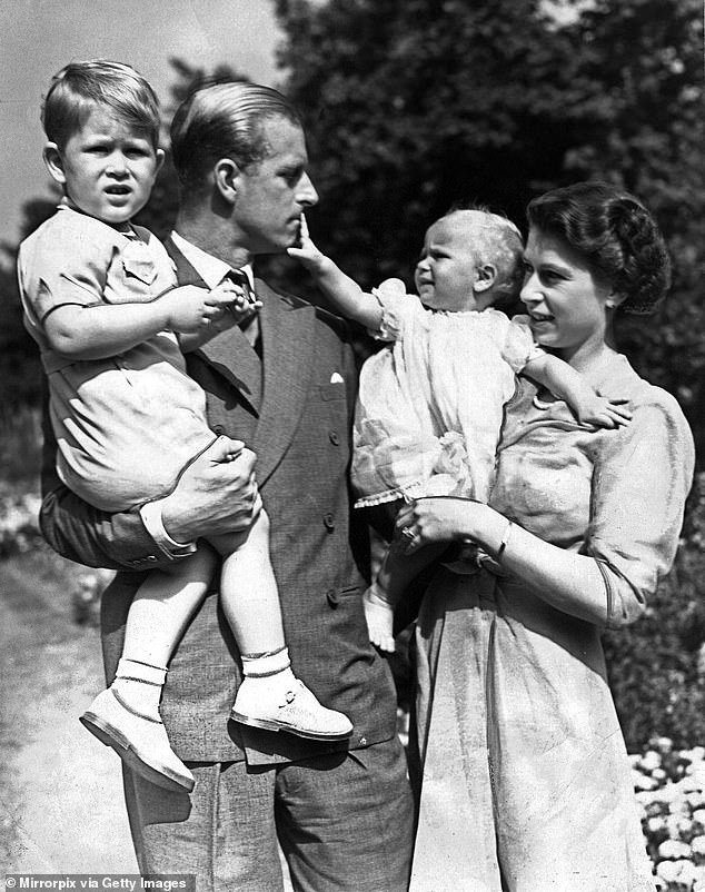 The late Queen Elizabeth II and her husband Prince Philip with their two children Prince Charles and Princess Anne (circa 1951)