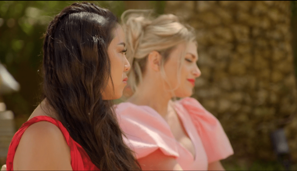 Screenshot of three women sitting outdoors.
