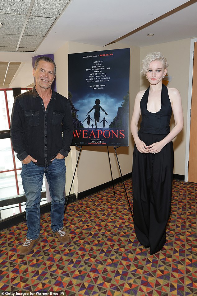 Garner had traded her standard tightly curled blond locks for long brunette waves to play Ellison; pictured with Weapons costar Josh Brolin on August 4 in NYC