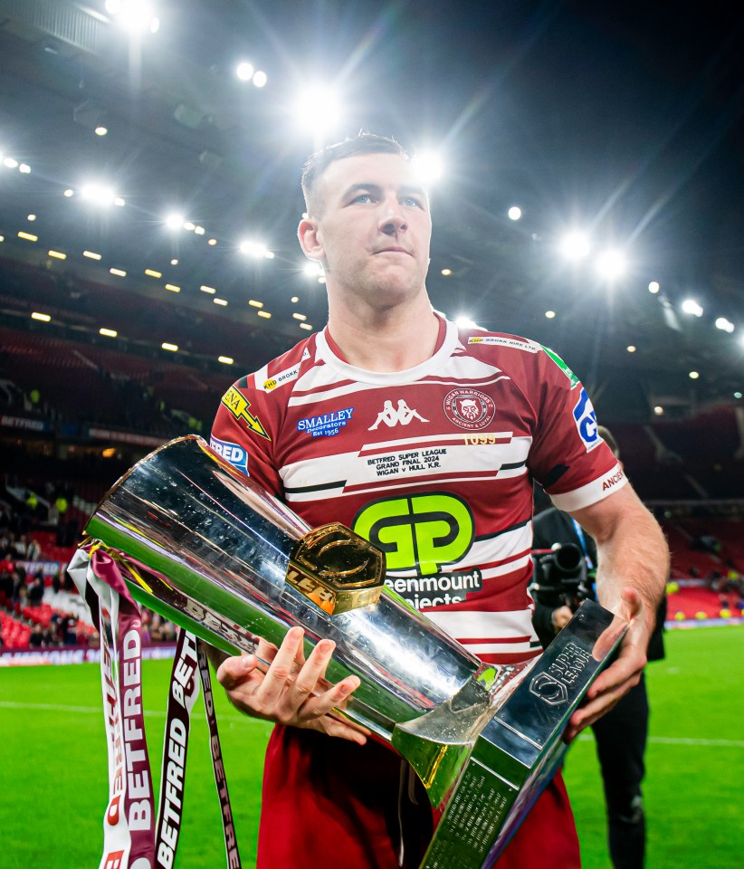 Rugby player holding the Grand Final trophy.