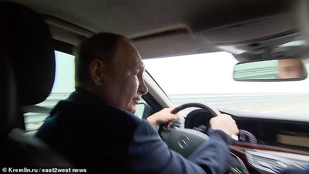 Body double? Vladimir Putin drives a Mercedes over the missile-damaged Crimean Bridge in 2022