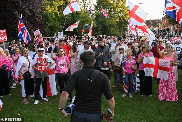 It comes amid rising tensions in Britain, with dozens of demonstrations held outside asylum seeker hotels in recent weeks. Pictured: Protesters outside The Bell Hotel in Epping, Essex last week