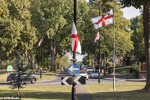St George's and Union Jack flags tied to lamp posts around Weoley Castle
