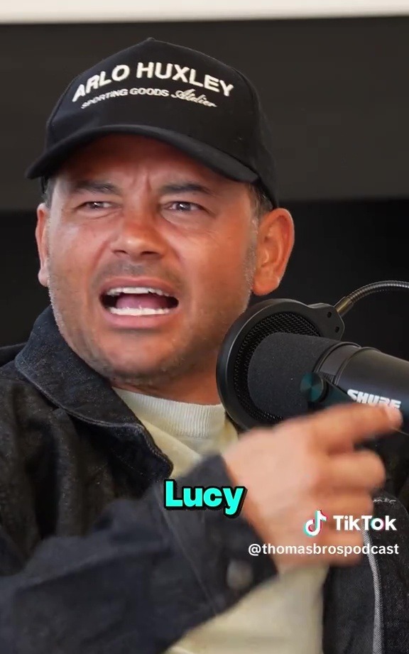 Man speaking into a microphone on the Thomas Bros Podcast.